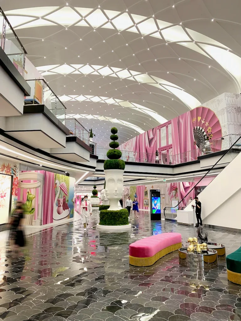 An interior court at American Dream with intricate ceiling and oversixed topiaries